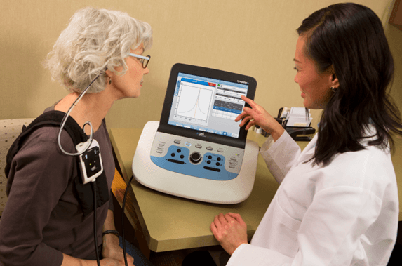 An audiologist reviewing a tympanogram with a patient
